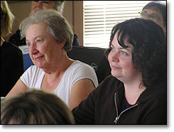 Two women listening to presentation